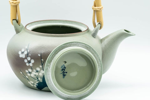 Japanese Tea Set - Green Arita-yaki Debeso Dobin Teapot with 2 Lidded Yunomi Teacups - front view of the teapot showing the spout and white plum blossoms
