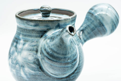 Elevated three-quarter view showing the body and patterned lid.