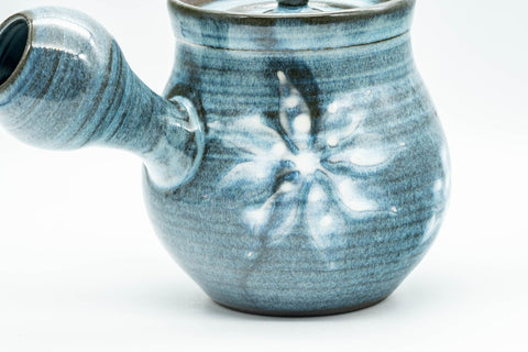 A further three-quarter view of the blue teapot with handle and spout visible.