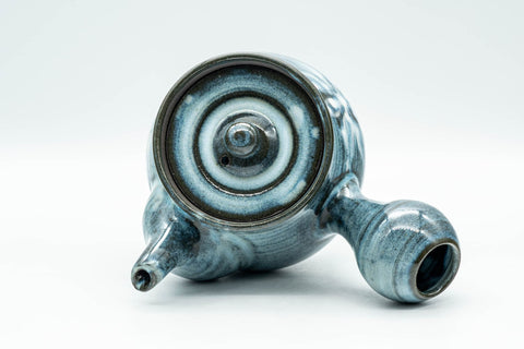 Overhead view of the teapot with the lid in place and handle extended.