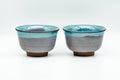 Pair of blue turquoise drip-glazed Agano-yaki yunomi shown side by side, front view
