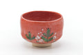Red Raku-yaki chawan, front view hand-painted with small flowers over the red glaze.