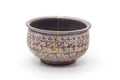 The kensui rotated to show the gold kintsugi crack running across the rim