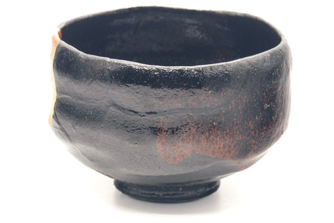 Black raku kintsugi chawan, opposite side view showing more dark glaze and reddish tones