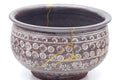 Closeup of the exterior wall detailing the stamped white chrysanthemum mishima and gold kintsugi