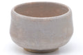 Wider view showing the substantial rounded form and pale glaze.