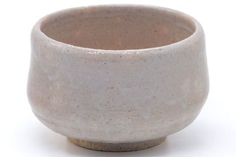 Wider view showing the substantial rounded form and pale glaze.