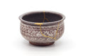Chrysanthemum mishima kensui water bowl, front view with white slip chrysanthemum designs over magenta glaze and gold kintsugi repair on the rim
