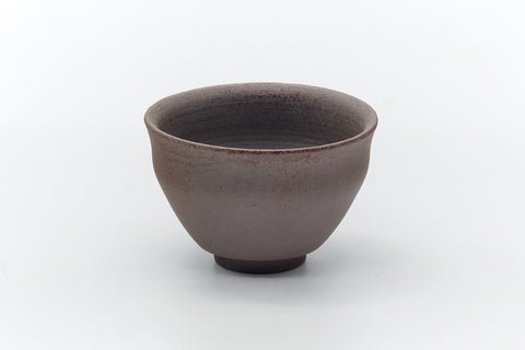 Another angle of the Bizen teacup showing earthy brown-and-grey surface variation.