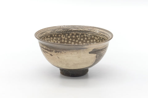 Front view of the mishima chawan showing the slip-inlay decoration and rim.