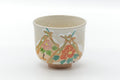 Beige Kiyomizu-yaki winter chawan, front view hand-painted with flowers and a seasonal scene.