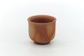 Small Hidasuki Bizen yunomi teacup on a footed base, three-quarter view showing the buff clay marked with red-orange straw-fire (hidasuki) streaks