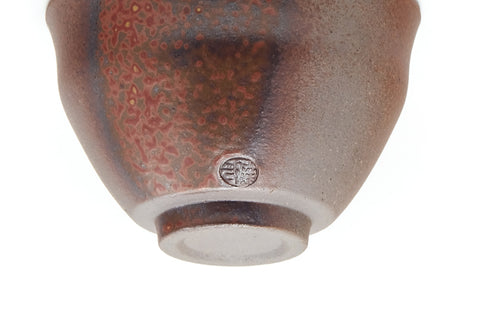 Angled underside view showing the foot and a maker's stamp on the base.