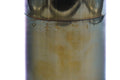 Close-up of the tea canister body showing the mottled patina and warm tones of the metal surface