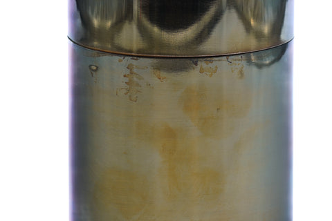 Close-up of the tea canister body showing the mottled patina and warm tones of the metal surface