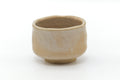 Opposite side of the beige chawan showing its plain glazed surface.