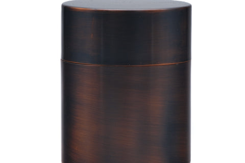 The closed metal tea canister shown from the front.