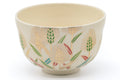 Angled view into the bowl interior with the wheat-motif decoration around the rim.