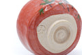 Closeup of the base showing the foot and red glaze edge.