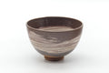 Dark brown wan-nari chawan, front view with broad white hakeme brushstrokes sweeping across the body.