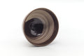 The chawan tilted to show its dark glazed interior with a swirl of white hakeme.