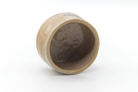 The chawan tilted to show its glazed interior well.