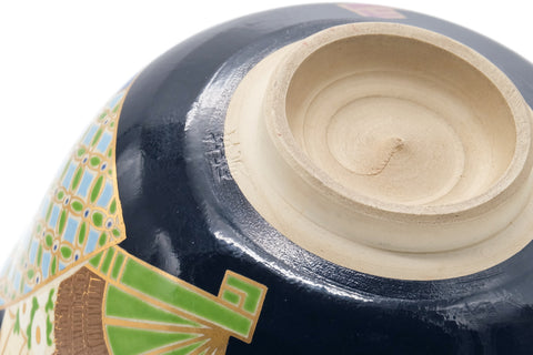 Underside and foot closeup showing the pale foot ring and fan motifs