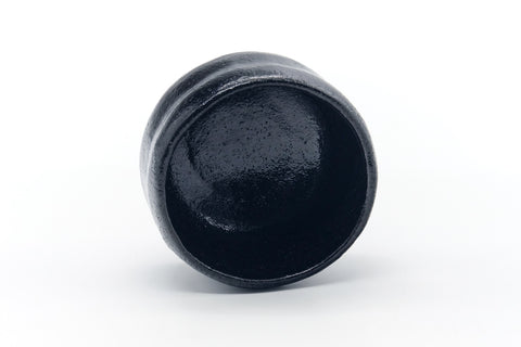 Overhead view into the bowl showing the dark glazed interior and irregular rim.
