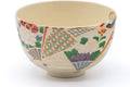 Side view showing the geometric floral motif wrapping around the bowl.