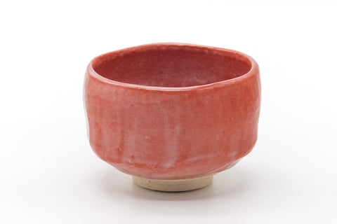 Side view of the matcha bowl showing the all-over red Raku glaze.
