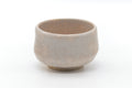 Front view showing the pale cream glaze and rounded rim.