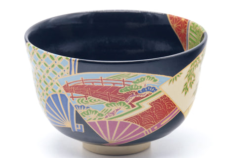 Three-quarter view showing the colourful fan motifs on black glaze