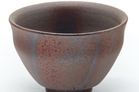 Close-up of the flared rim and the reddish, grey kiln-fired surface.