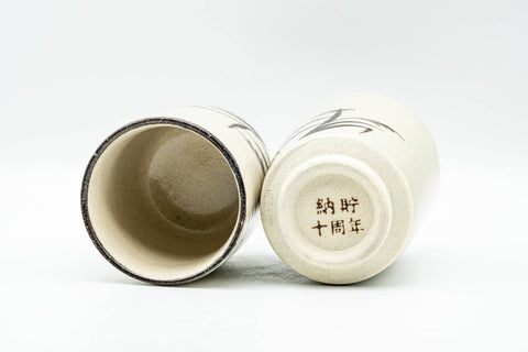 Japanese Teacups - Pair of Beige Long Grass Yunomi - 110ml - the pair tilted to show the interiors and base stamps