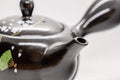 Japanese Kyusu - Sakura Cherry Blossom Black Kurodei Tokoname-yaki Teapot - 300ml - top-down angled view with the lid on and handle to the right