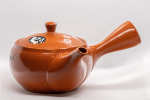 Japanese Kyusu - 帯アミ Floral Red Shudei Tokoname-yaki Obi-ami Teapot - 265ml - three-quarter front view of the red shudei teapot with white floral decoration and side handle