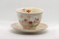 Japanese Teacups - Pair of Beige Floral Yunomi with Saucers - 150ml - front view of a cup resting on its saucer