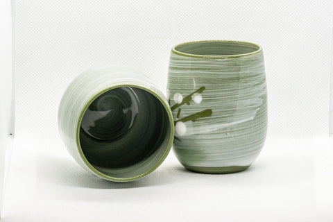 Japanese Teacups - Meoto Pair of Green Floral Yunomi - one teacup resting on its side showing the dark interior beside one upright