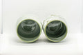 Japanese Teacups - Meoto Pair of Green Floral Yunomi - the pair resting on their sides showing the interiors and footrings