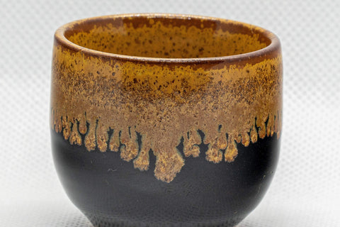 Japanese Teacup - Drip-Glazed Guinomi - 35ml - closeup of the amber drip glaze over the black exterior