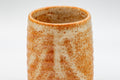 Japanese Teacups - Pair of Shino Glazed Tsutsu-gata Yunomi - 90ml - closeup of a single cup showing the ribbed orange shino glaze