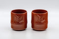 Japanese Teacups - Pair of 亮泉 朱泥 Tsutsu-gata Tokoname-yaki Yunomi - 140ml - three-quarter view of the pair of red clay cups with bamboo engraving