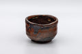 Japanese Pottery - Hand-formed Yunomi Teacup - 55ml - front view of the brown-black glazed cup