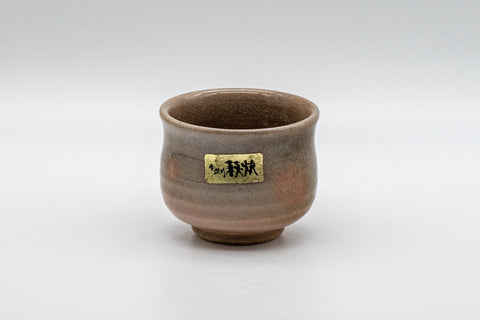 Japanese Teacup - Hagi-yaki Yunomi by Hagiden Kiln - 90ml - front view of the Hagi-yaki yunomi with the kiln label, showing the crazed peach gohonte glaze