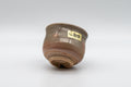 Japanese Teacup - Hagi-yaki Yunomi by Hagiden Kiln - 90ml - tilted view showing the kiln label and glaze