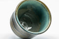 Japanese Teacups - Set of 3 Olive Green Turquoise Koishiwara-yaki Yunomi - 100ml - a single teacup tilted to show the turquoise glazed interior