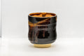 Japanese Teacup - Drip-Glazed Tsutsu-gata Yunomi - 160ml - angled view of the gold-speckled drip-glazed exterior
