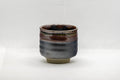 Japanese Teacup - Tenmoku Glazed Tsutsu-gata Yunomi - 65ml - front view showing the red and black tenmoku glaze at the lip