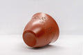 Japanese Teacup - Floral Tokoname-yaki Yunomi - angled view showing the engraved floral design on the brick-red shudei clay