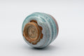 Japanese Teacup - Turquoise Obori Soma-yaki Guinomi - tilted on its side showing the footring and base